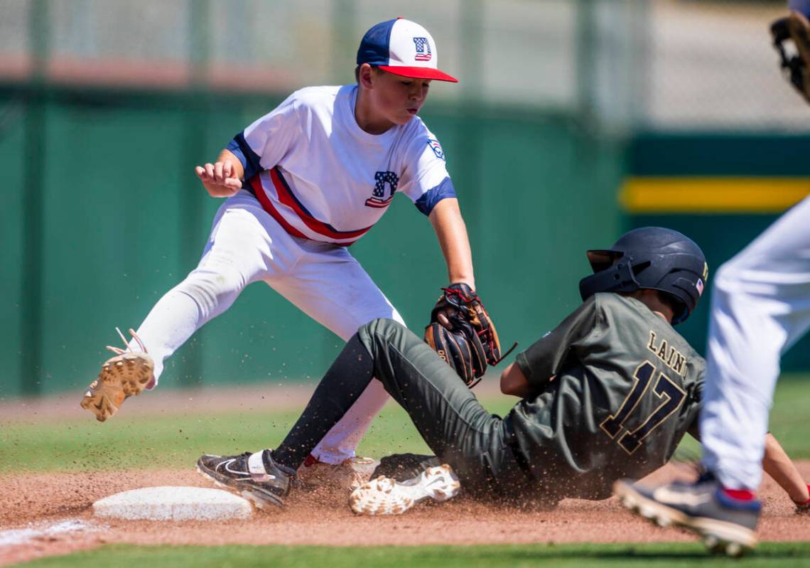 Nevada base runner Dominic Laino (17) slides safely into third base against Utah infielder Drex ...