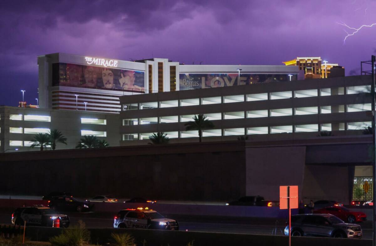 Lightning flashes over the Strip as police investigate a shooting on Interstate 15 southbound o ...