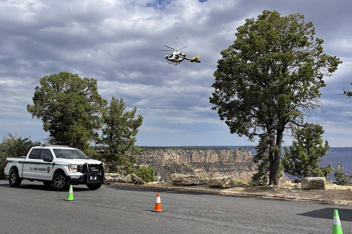 A helicopter flies above the Grand Canyon as authorities recover the body of Leticia A. Castill ...