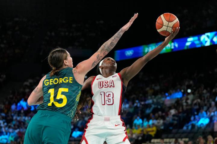 Cayla George (15), of Australia, attempts to block the shot of United States' Jackie Young (13) ...