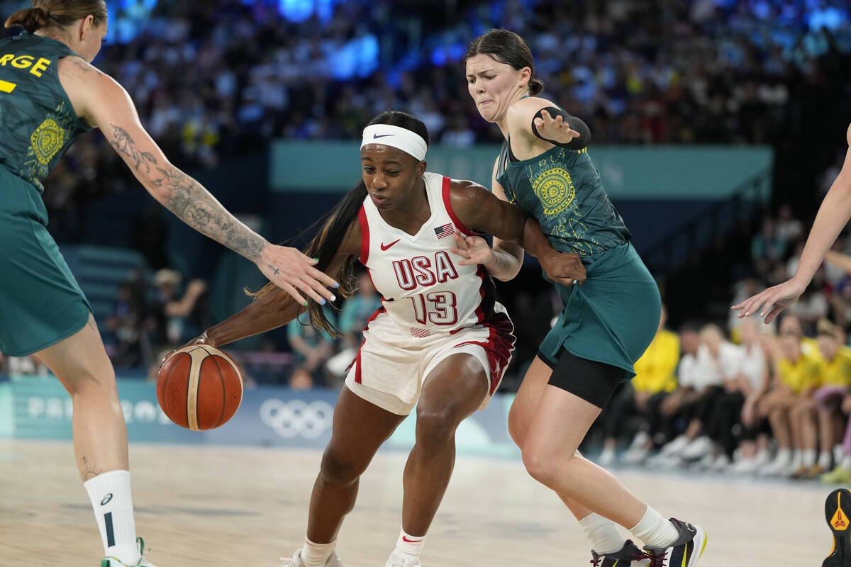 United States' Jackie Young (13) drives past Jade Melbourne (2), of Australia, during a women's ...