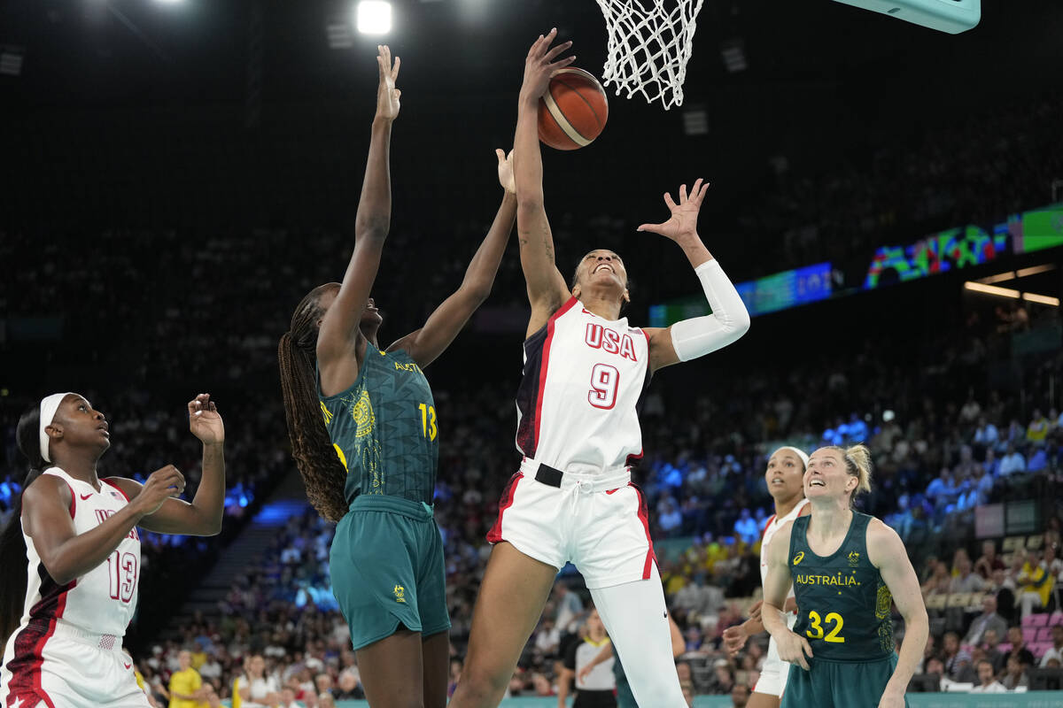 Ezi Magbegor (13), of Australia, and United States' A'ja Wilson (9) go for a rebound during a w ...