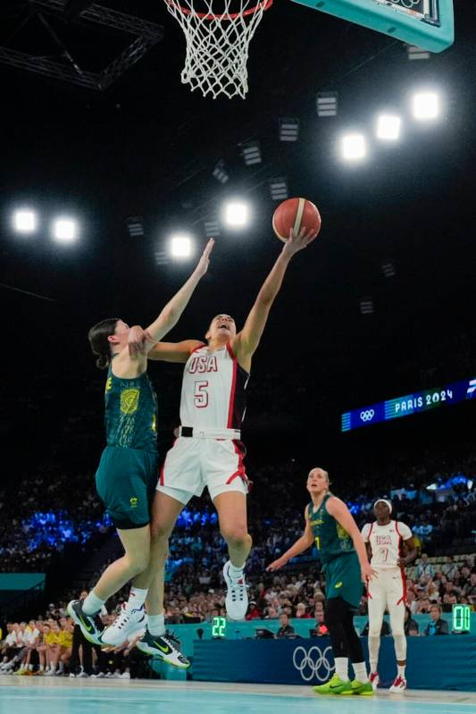 United States' Kelsey Plum (5) goes up under pressure form Jade Melbourne (2), of Australia, du ...