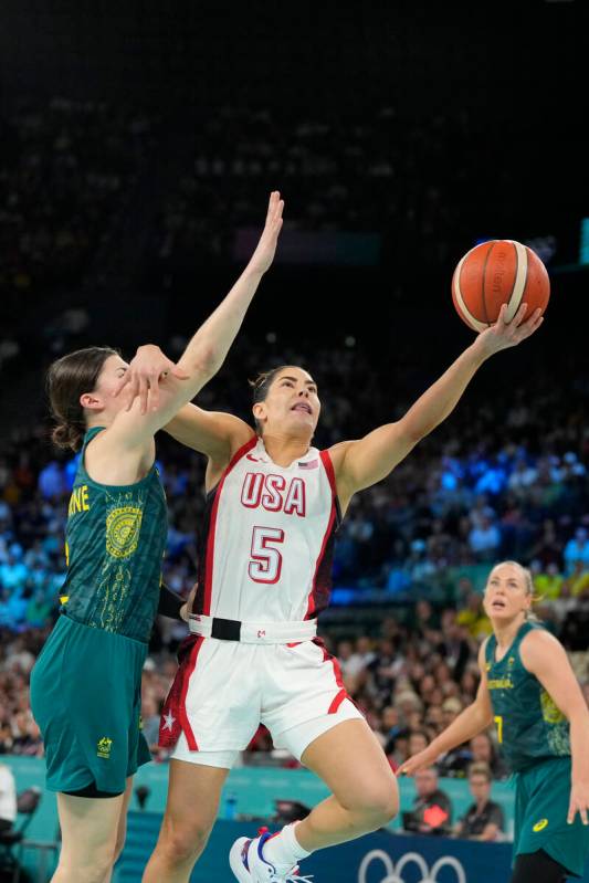 United States' Kelsey Plum (5) goes up for a basket against Jade Melbourne (2), of Australia, d ...