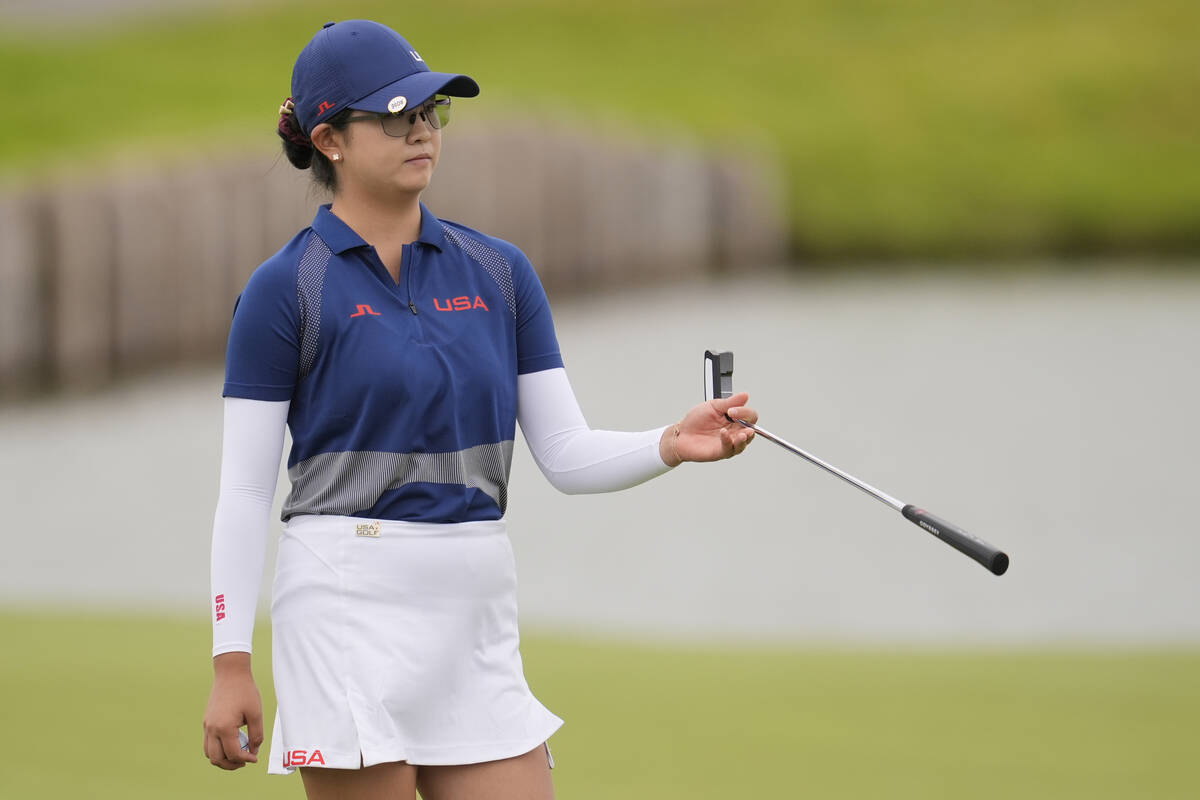 Rose Zhang, of the United States, hands her club to her caddie on the 2nd green during the thir ...