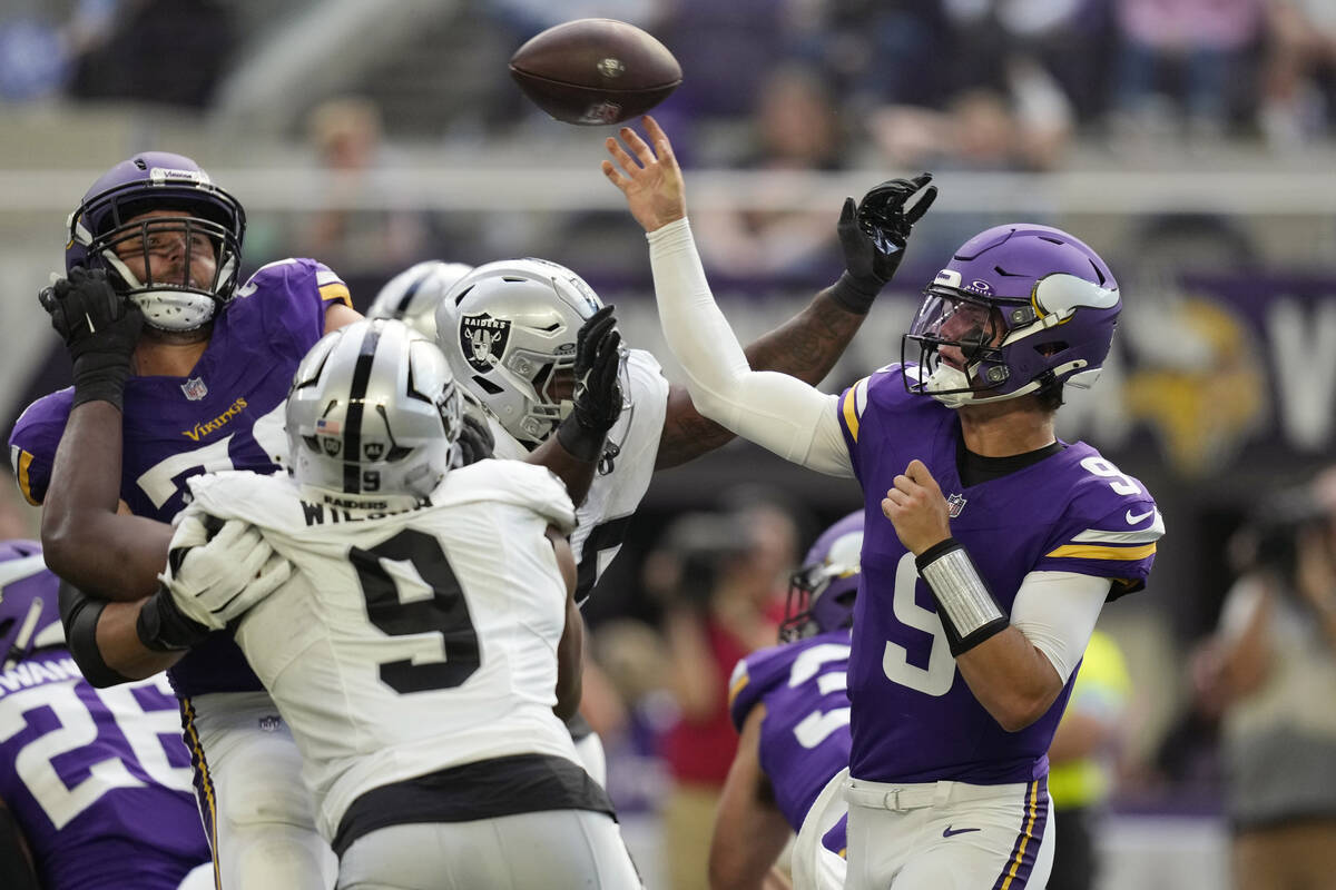 Minnesota Vikings quarterback J.J. McCarthy (9) throws against the Las Vegas Raiders under pres ...