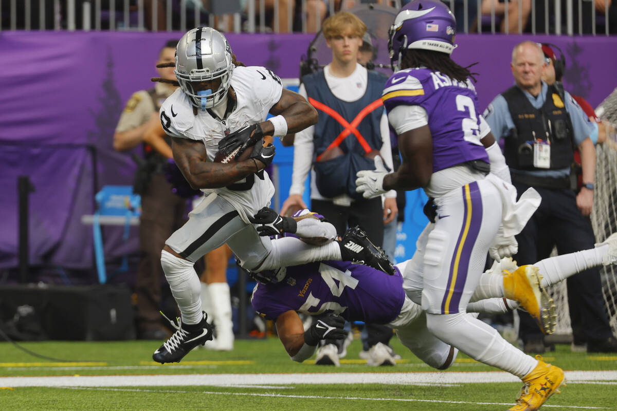 Las Vegas Raiders running back Ameer Abdullah (8) runs over Minnesota Vikings linebacker Kamu G ...