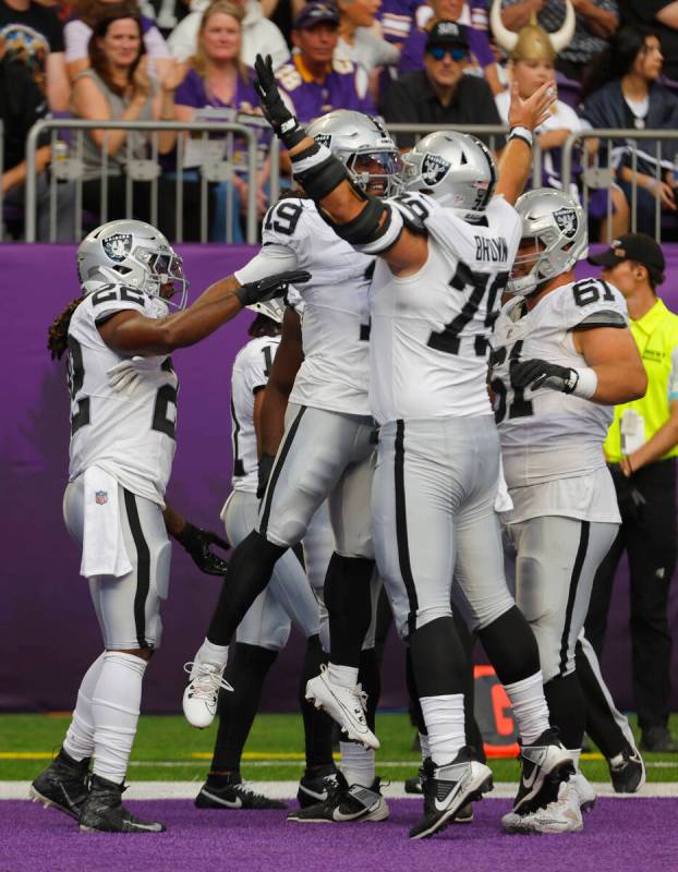 Las Vegas Raiders wide receiver DJ Turner (19) celebrates his touchdown with teammate Ben Brown ...