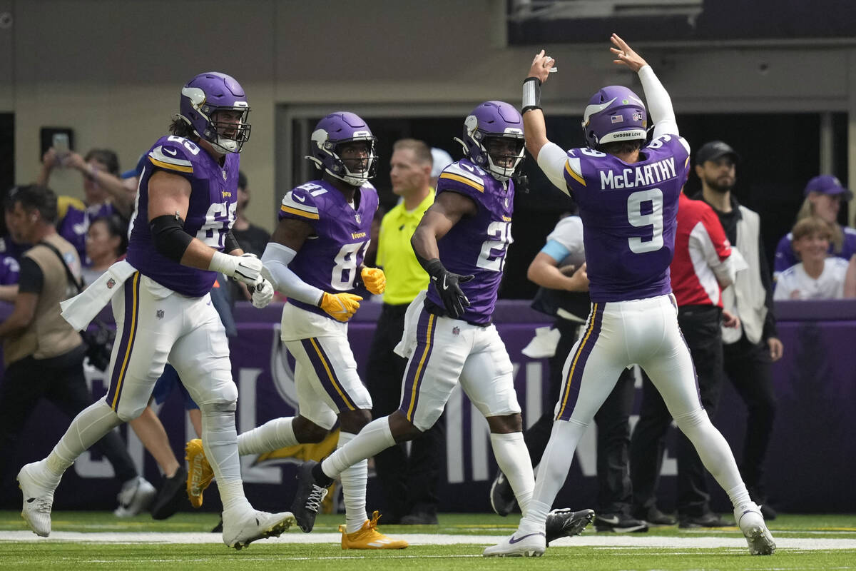 Minnesota Vikings quarterback J.J. McCarthy (9) celebrates with teammates after a touchdown aga ...