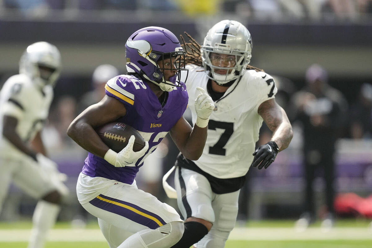 Minnesota Vikings running back Ty Chandler (32) runs against Las Vegas Raiders safety Tre'von M ...