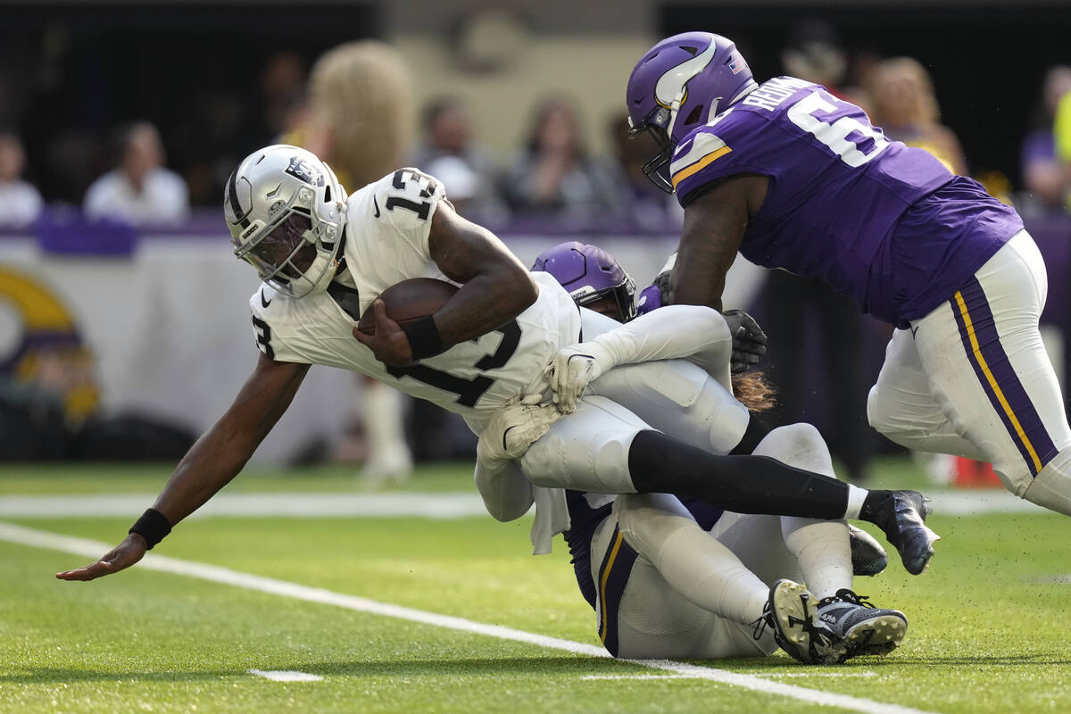 Las Vegas Raiders quarterback Anthony Brown Jr. (13) is sacked by Minnesota Vikings defensive t ...