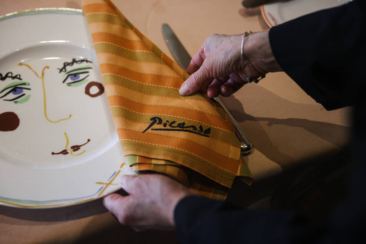 Busser Brenda Sanchez prepares a table for dinner service at Picasso at the Bellagio hotel-casi ...