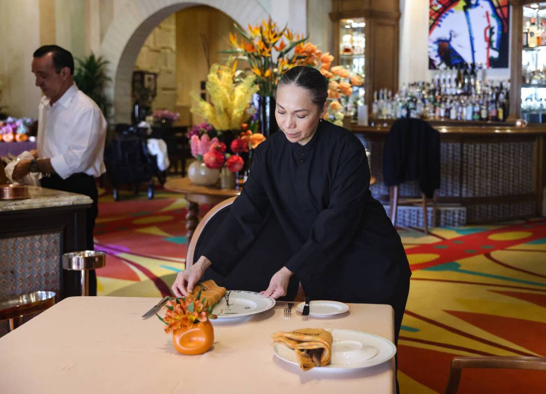 Busser Brenda Sanchez prepares a table for dinner service at Picasso at the Bellagio hotel-casi ...