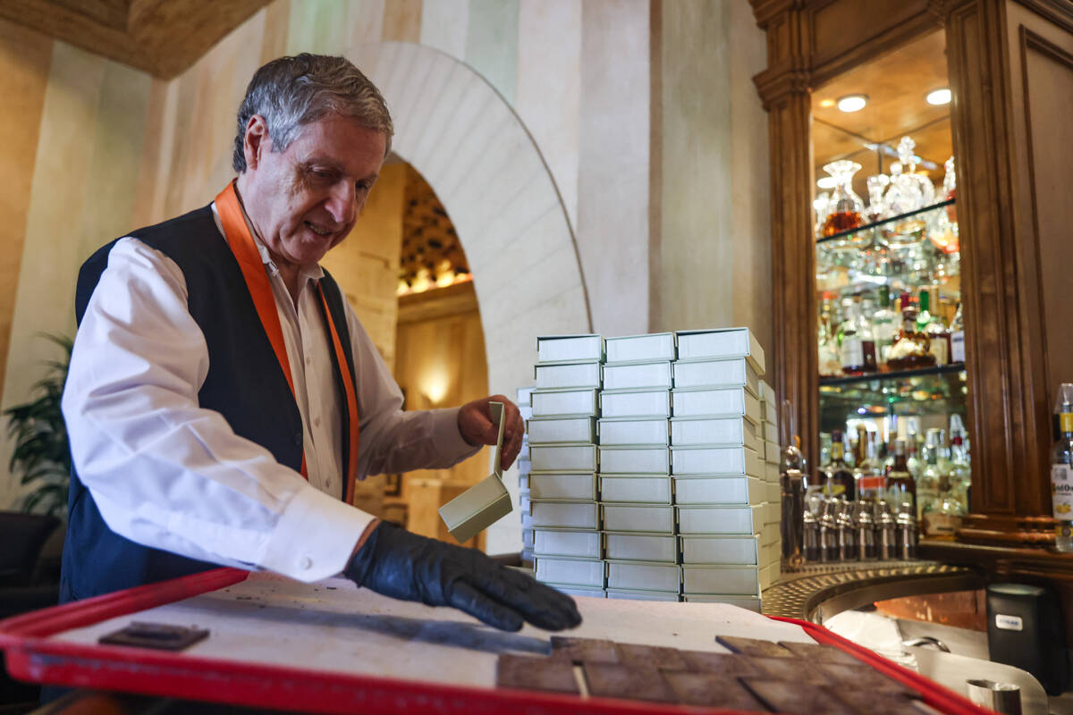 Server Alain Boscarolo prepares chocolates, shaped with a picture of Pablo Picasso’s &#x ...