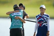 Lydia Ko, of New Zealand, hugs her caddie Paul Cormack, as she cries, on the 18th green after w ...