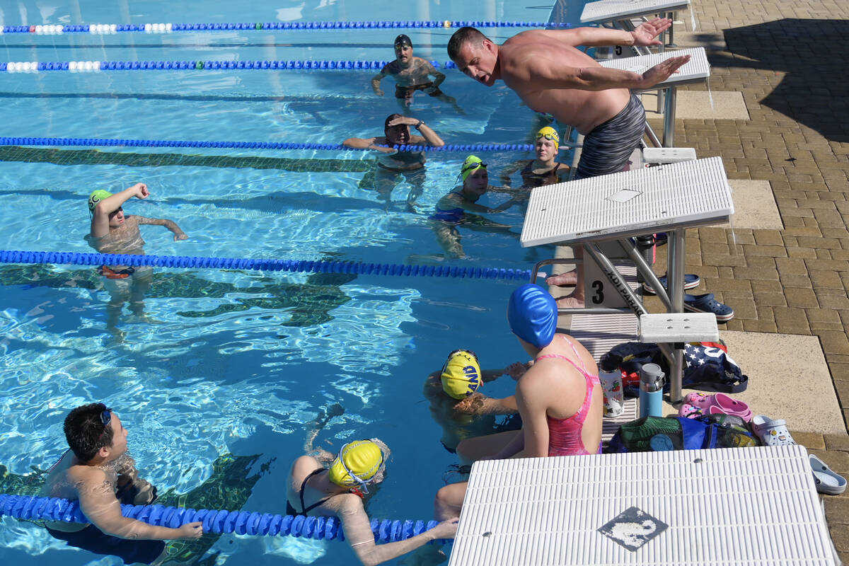 Current world record holder and 12-time Olympic medalist Ryan Lochte gives pointers during a sw ...