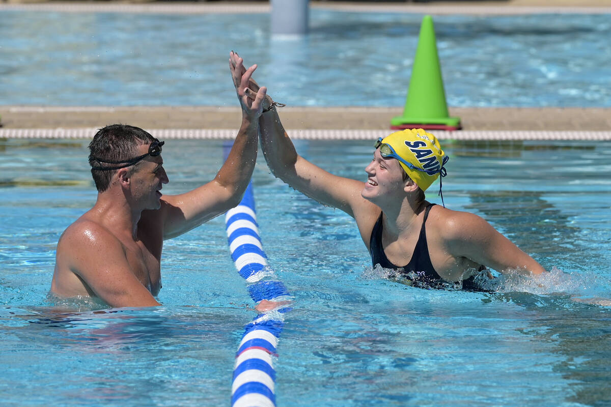 Current world record holder and 12-time Olympic medalist Ryan Lochte gives a high-five to E.J. ...