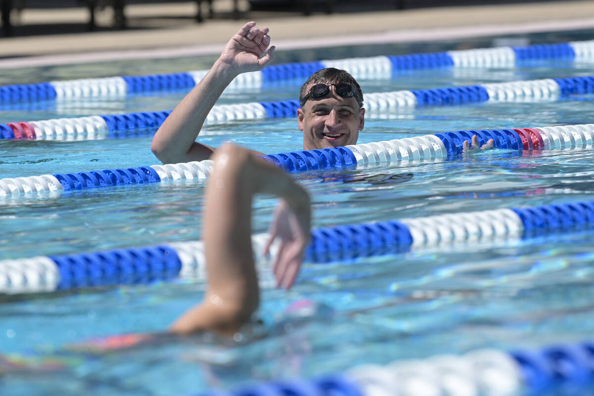 Current world record holder and 12-time Olympic medalist Ryan Lochte assesses a participant dur ...