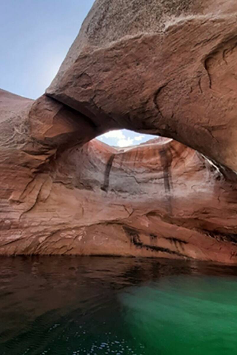 This photo shows Double Arch prior to collapse in Rock Creek Bay of the Glen Canyon National Re ...