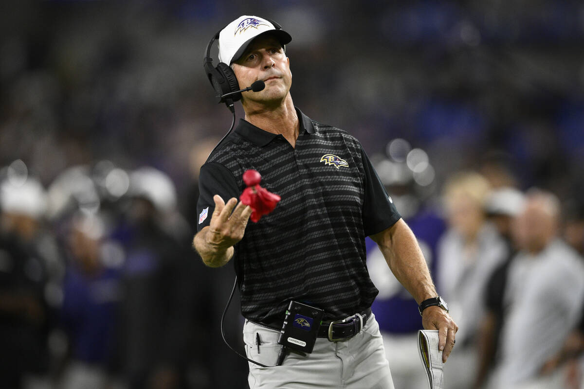 Baltimore Ravens' John Harbaugh tosses a challenge flag during the second half of a preseason N ...