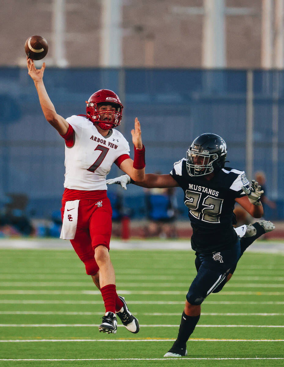 Arbor View quarterback Thaddeus Thatcher (7) yells as he throws the ball to a teammate while Sh ...