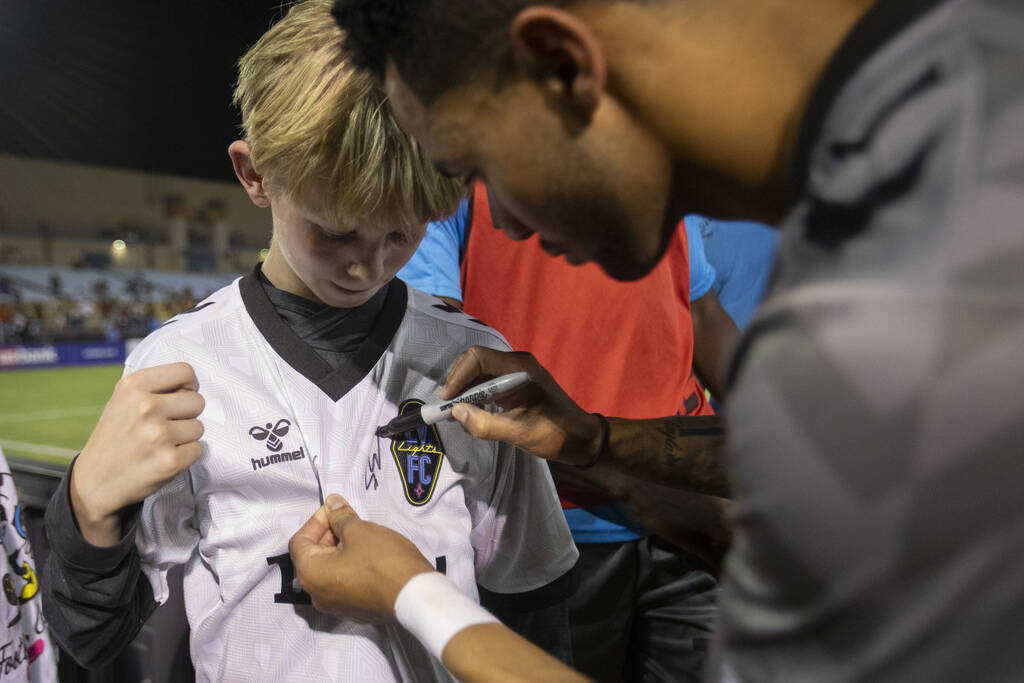 Young fans have their shirts signed by Las Vegas Lights FC players after a USL Championship soc ...