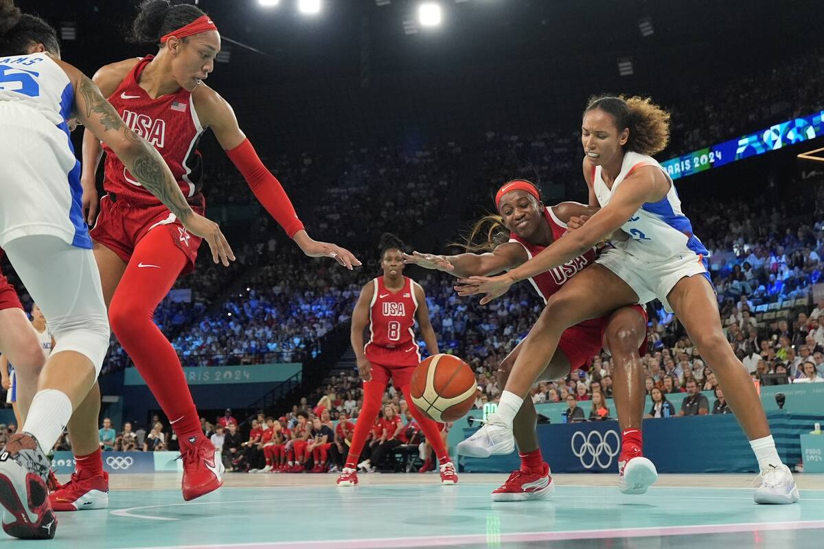 United States' Jackie Young (13) and Marieme Badiane (22), of France, go after a loose ball dur ...