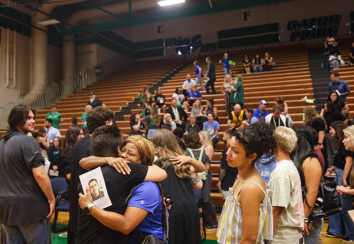 Friends, family and students congregate following a memorial service for Eric Johnston, a forme ...