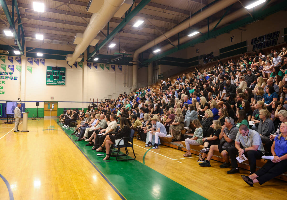 Friends, family and students listen to Bill Hemburger, a friend and colleague of Eric Johnston, ...