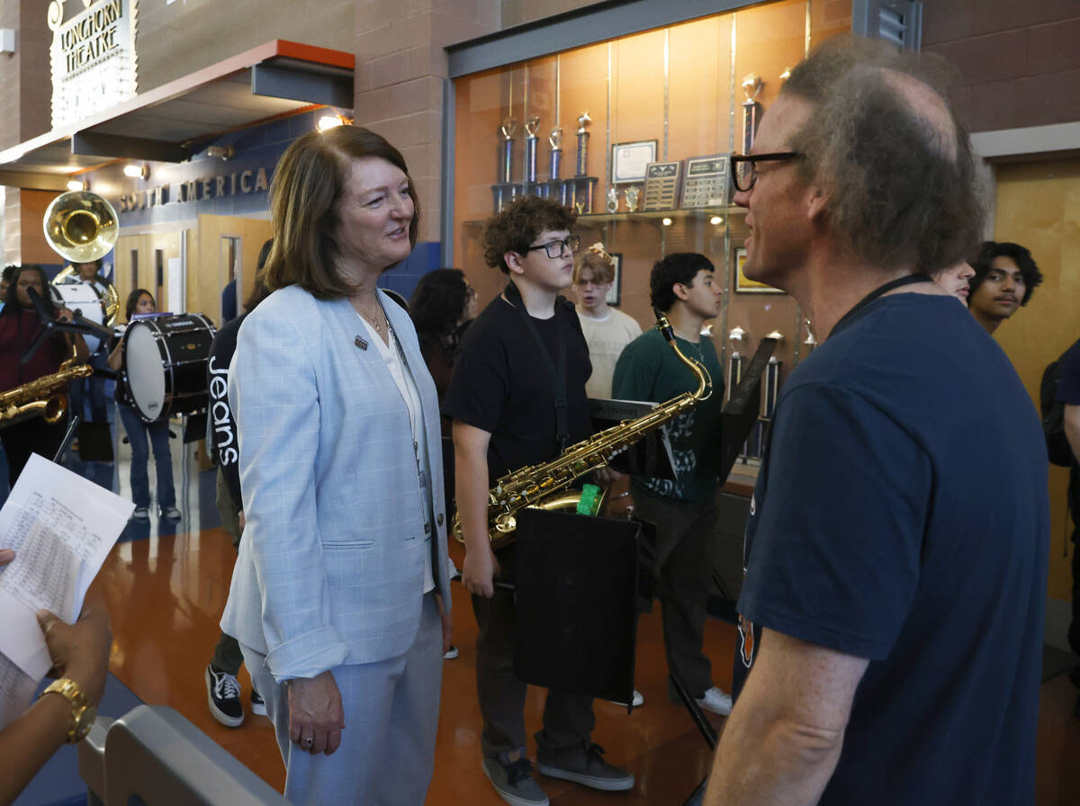 Interim Superintendent Brenda Larsen-Mitchell, left, speaks to Legacy High School music teacher ...