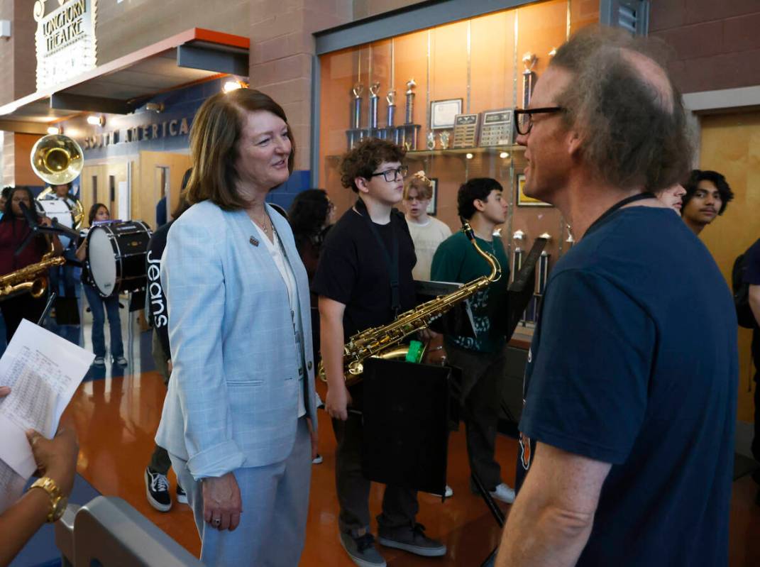 Interim Superintendent Brenda Larsen-Mitchell, left, speaks to Legacy High School music teacher ...