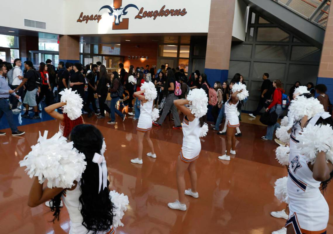 Legacy High School cheerleaders perform as students arrive during the first day of school on Mo ...