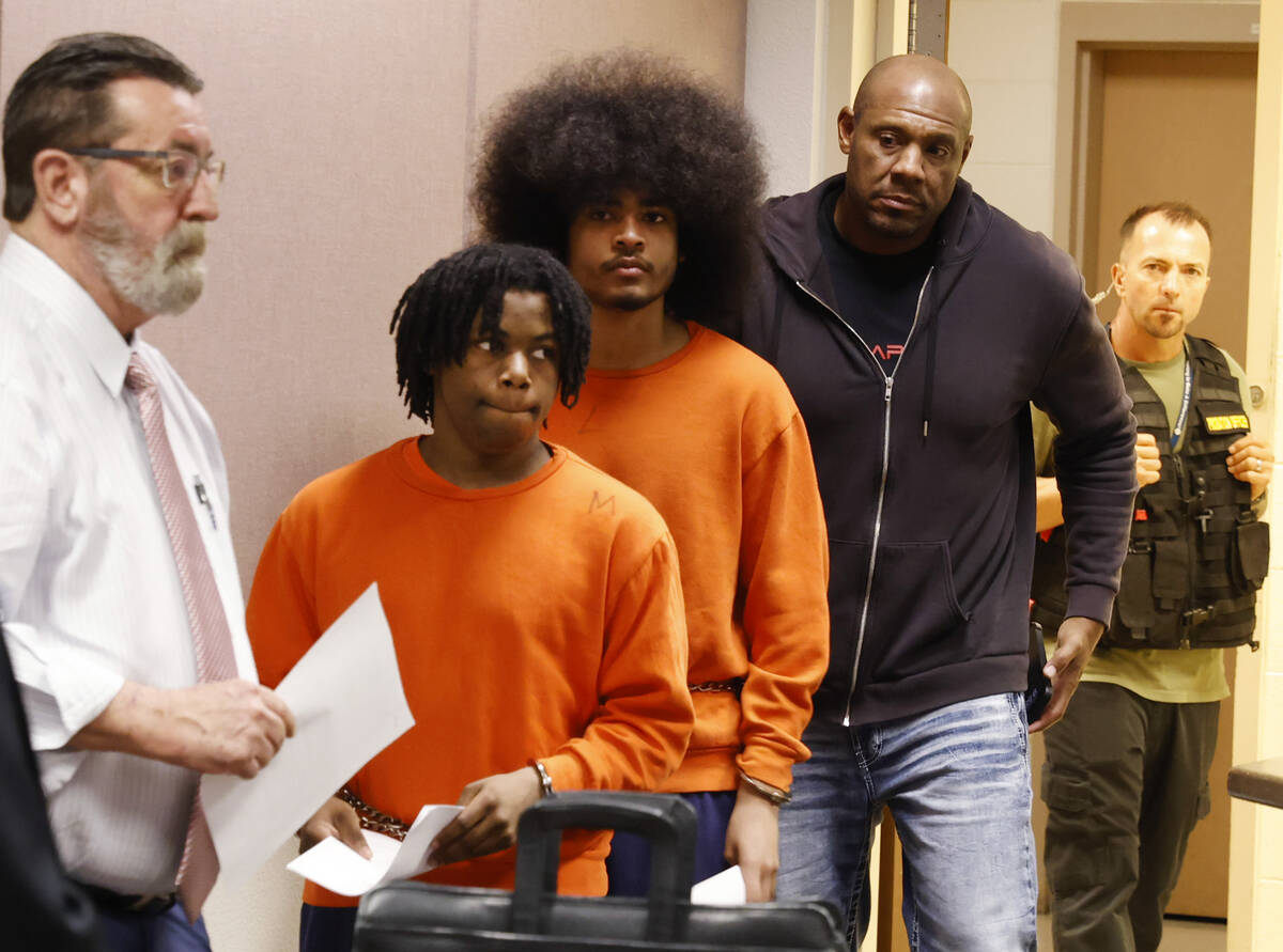 Gianni Robinson and Treavion Randolph are led into Juvenile Court for a hearing on Monday, Aug. ...