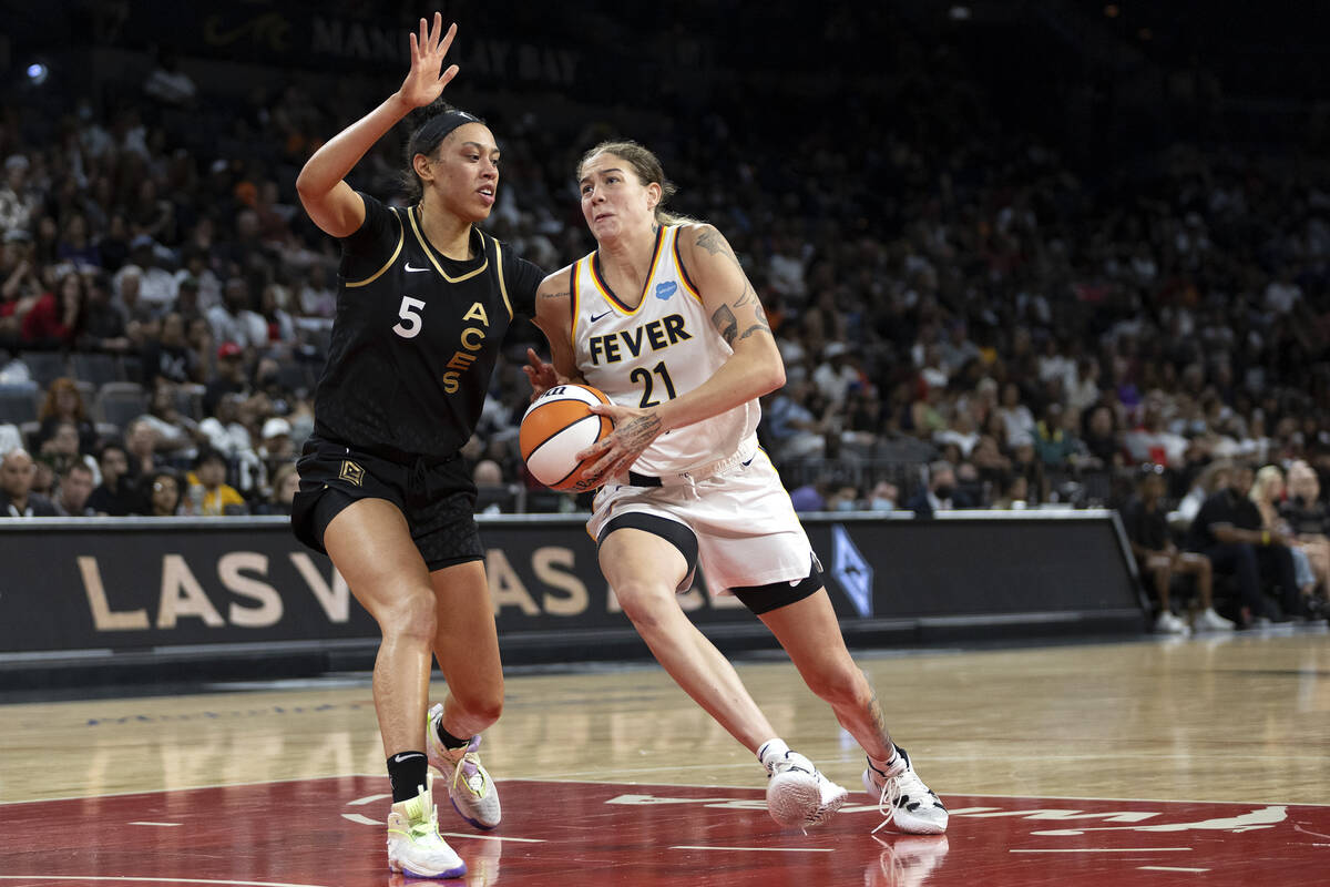 Indiana Fever forward Emily Engstler (21) drives around Las Vegas Aces forward Dearica Hamby (5 ...