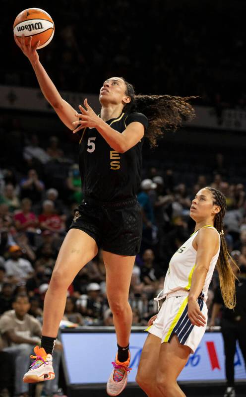 Aces forward Dearica Hamby (5) drives past Dallas Wings guard Veronica Burton (12) in the first ...