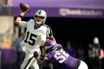 Las Vegas Raiders quarterback Gardner Minshew II (15) throws a pass as he is pressured by Minne ...