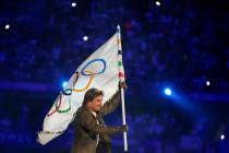 Tom Cruise carries the Olympic flag during the 2024 Summer Olympics closing ceremony at the Sta ...