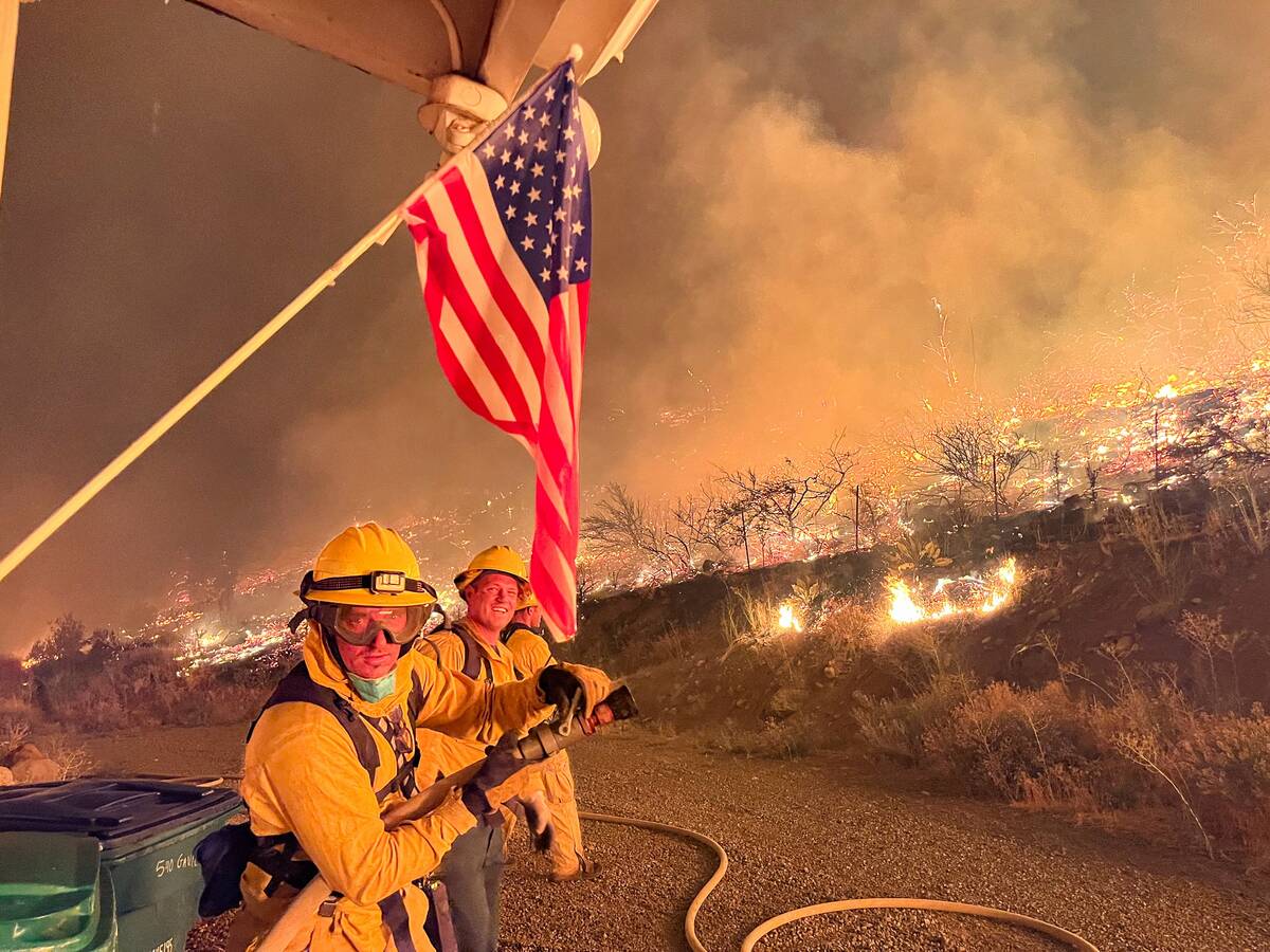 Firefighters work to contain the Gold Ranch Fire, burning near the town of Verdi in Washoe Coun ...