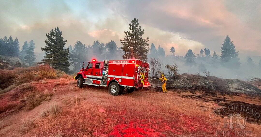 Firefighters work to contain the Gold Ranch Fire, burning near the town of Verdi in Washoe Coun ...