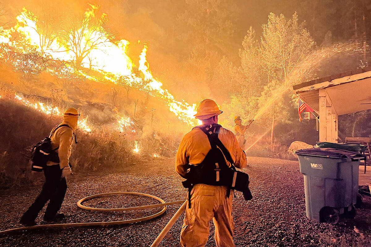 Firefighters work to contain the Gold Ranch Fire, burning near the town of Verdi in Washoe Coun ...