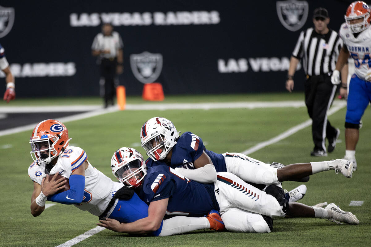 Bishop Gorman quarterback Melvin Spicer IV (15) is tackled by Liberty during the second half of ...