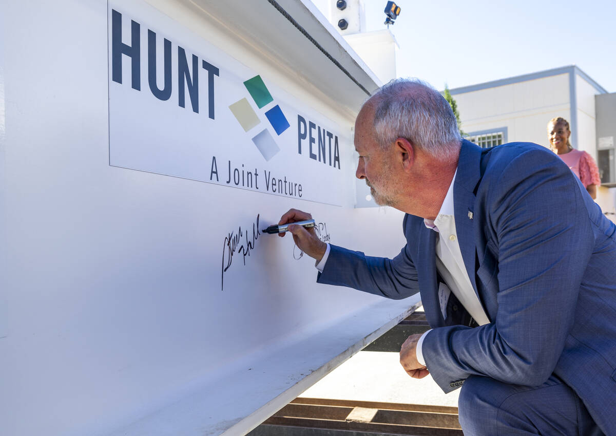 LVCVA President and CEO Steve Hill signs the beam during a topping-off ceremony for the Phase 3 ...