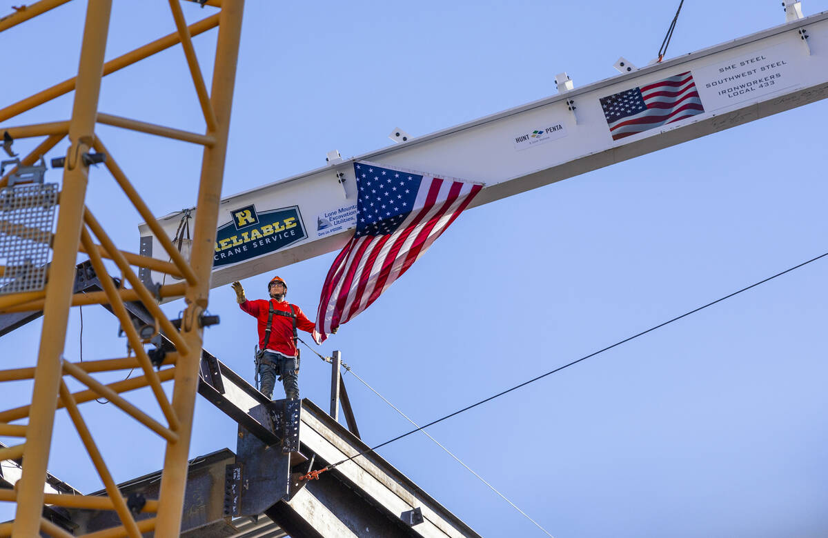 A worker guides the beam into place as the Las Vegas Convention and Visitors Authority holds a ...