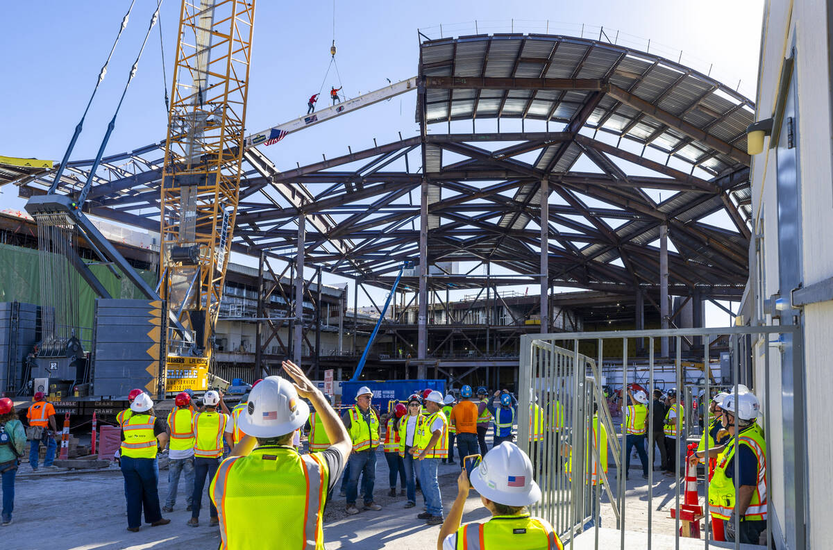 Workers prepare to remove the cables after securing the beam into place as the Las Vegas Conven ...