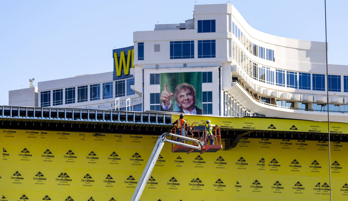 Workers continue the exterior construction as the Las Vegas Convention and Visitors Authority t ...