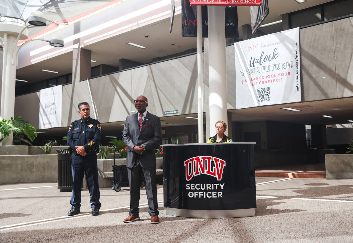 Musa Pam, vice president for facilities management, speaks to the press next to Arnold Vasquez, ...