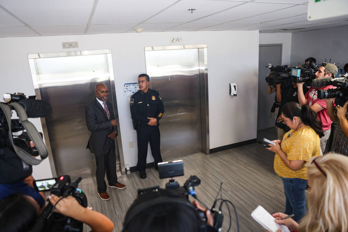 Musa Pam, vice president for facilities management, left, speaks to the media next to Arnold Va ...