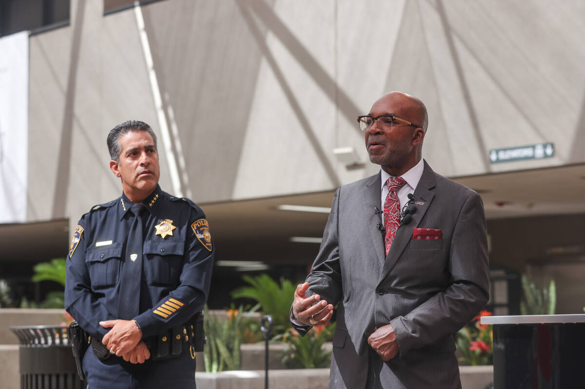 Musa Pam, vice president for facilities management, speaks to the press next to Arnold Vasquez, ...