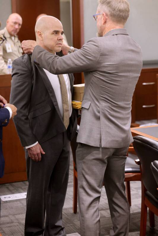 Defense attorney Robert Draskovich, right, adjusts the collar of his client Robert Telles prior ...