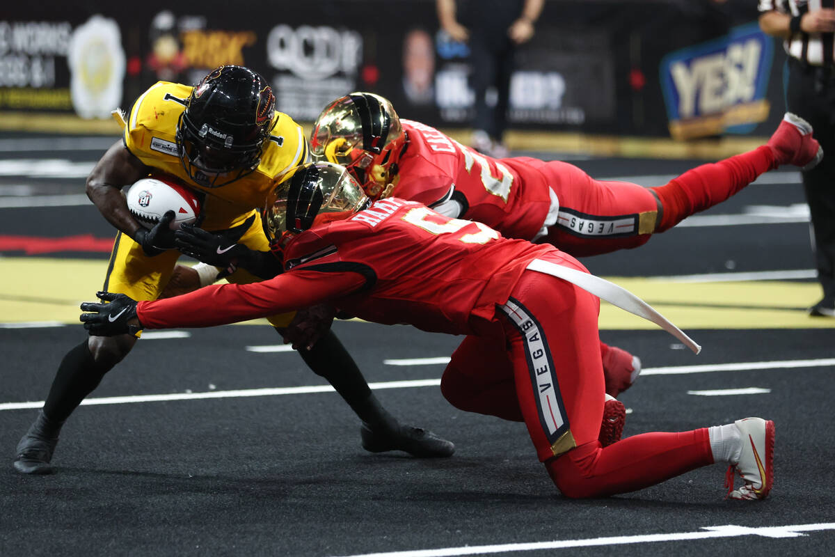 Tucson Sugar Skulls wide receiver Mike Carrigan (1) carries the ball up the field while Vegas K ...